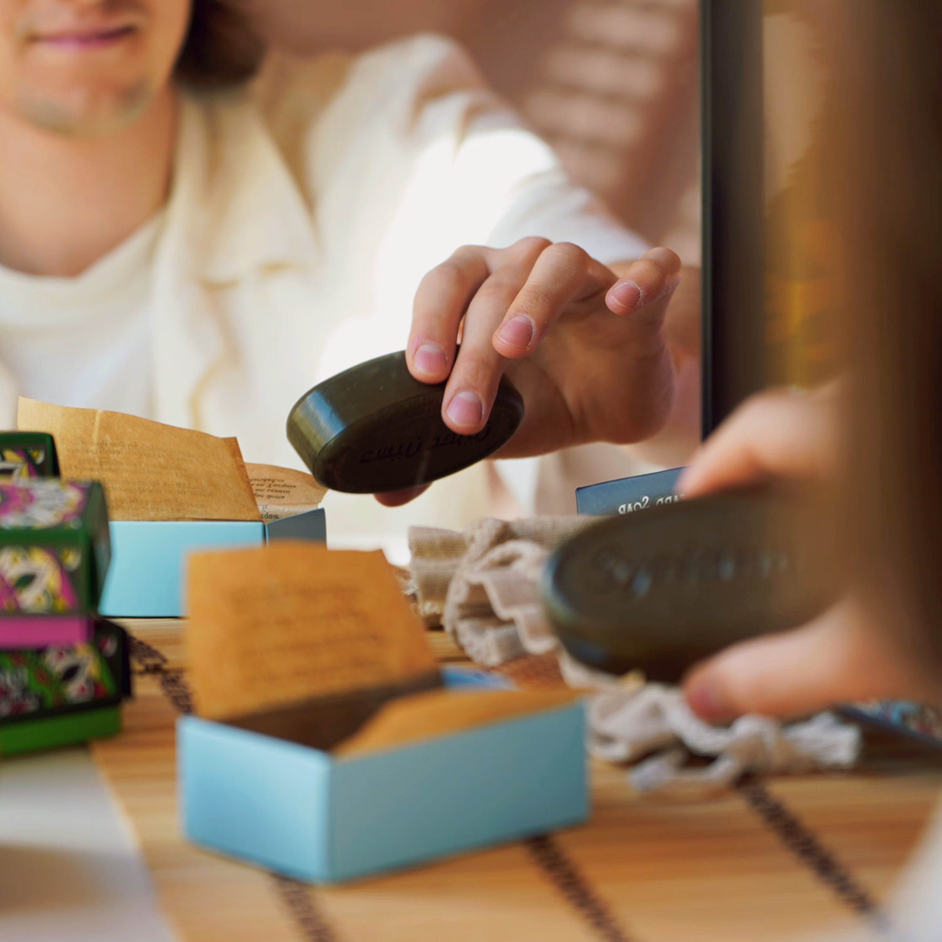 Black Musk Aleppo soap bar resting on a natural surface in a bathroom setting