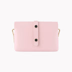Back view of pink leather mini bag showing vertical strap with two snap buttons