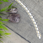 Magnetic Mobility Alexander's Moon 4in1 Magnetic Bracelet – top view – curved link layout on wooden surface