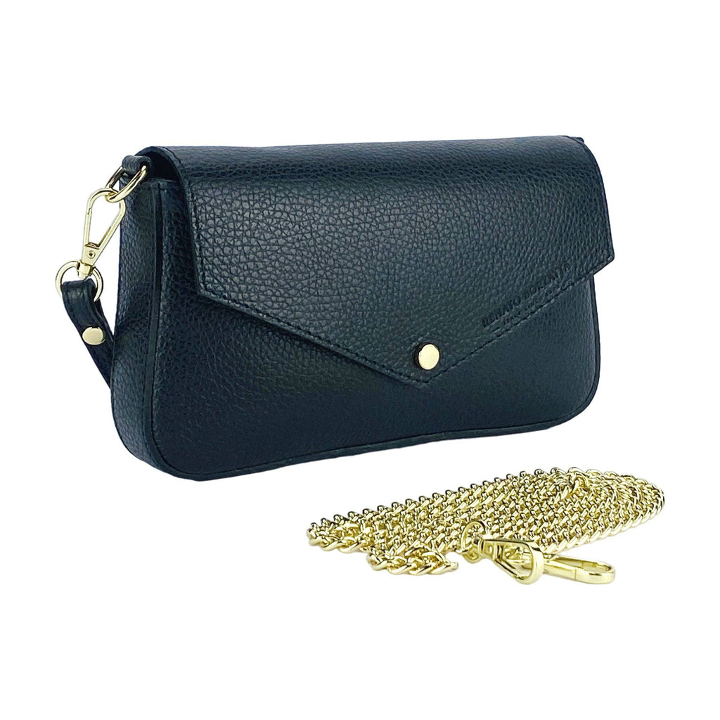 Black leather shoulder bag standing next to a detached gold chain strap