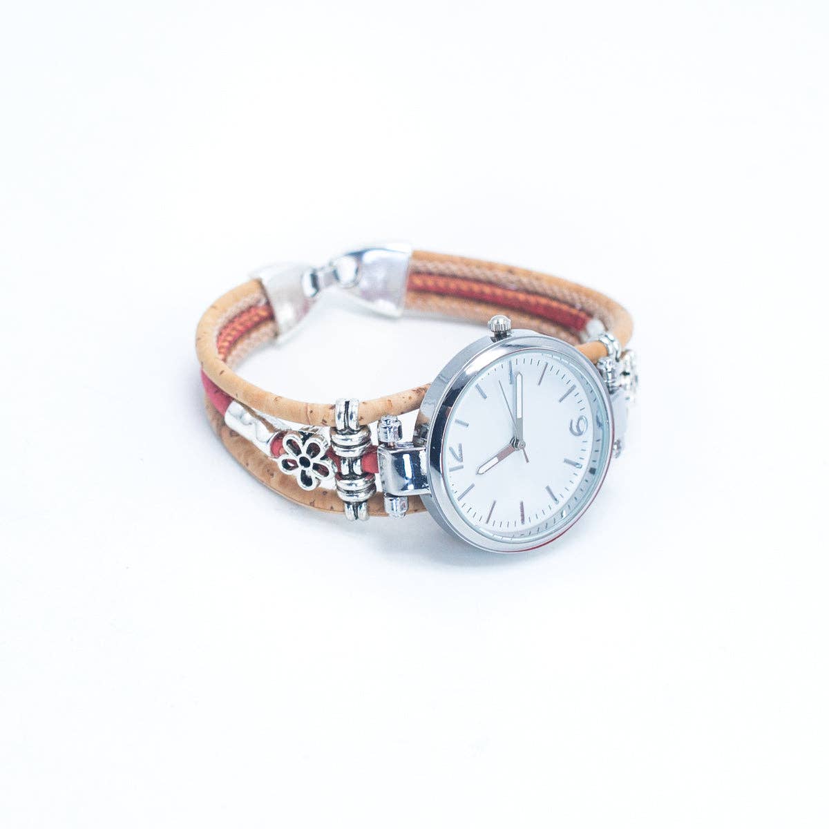Meninas Bonitas Cork Floral Accent Bracelet Watch 16x3cm – angle view – close-up of the polished metal watch case and floral alloy charms on a pink and natural cork strap.